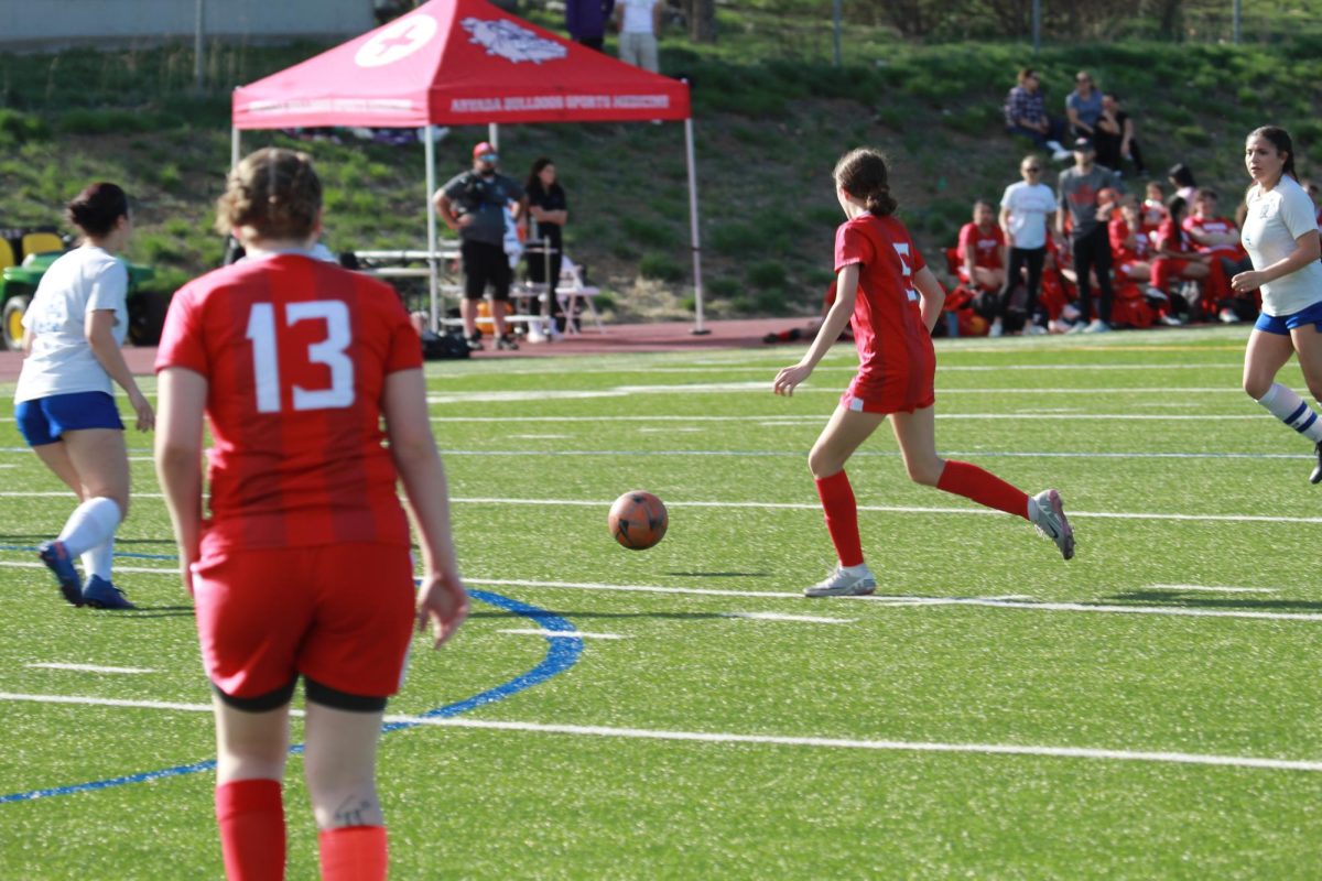 #5 Nora Rice driving the ball down field